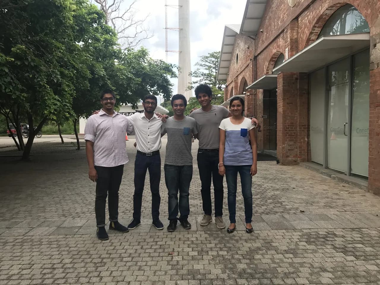 Five members of the early Motion Miracles team standing together outdoors