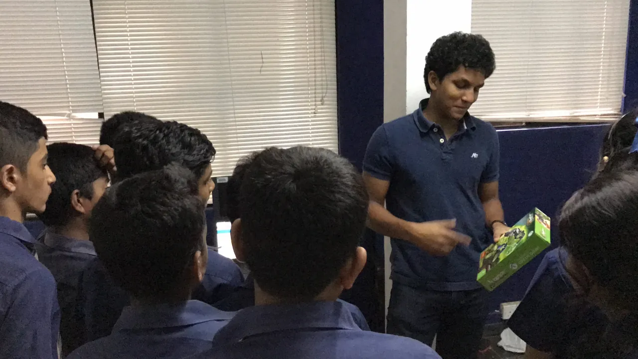 Anish sharing a book with students during a school visit